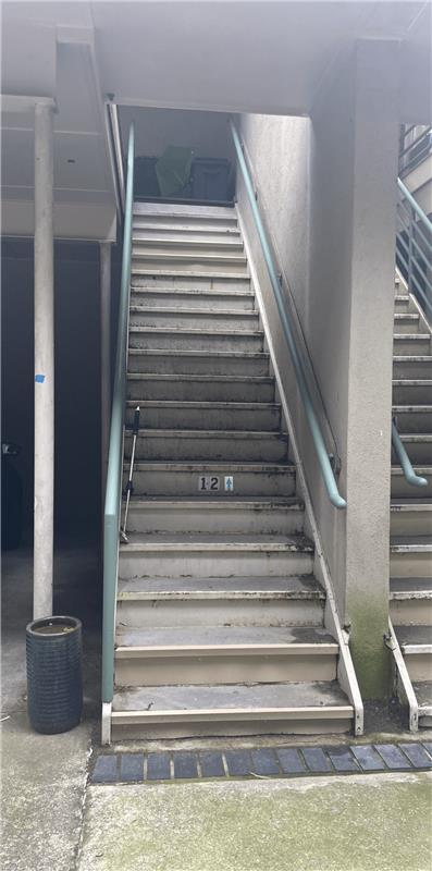 Before metal staircase repair showing rusted and damaged stairs